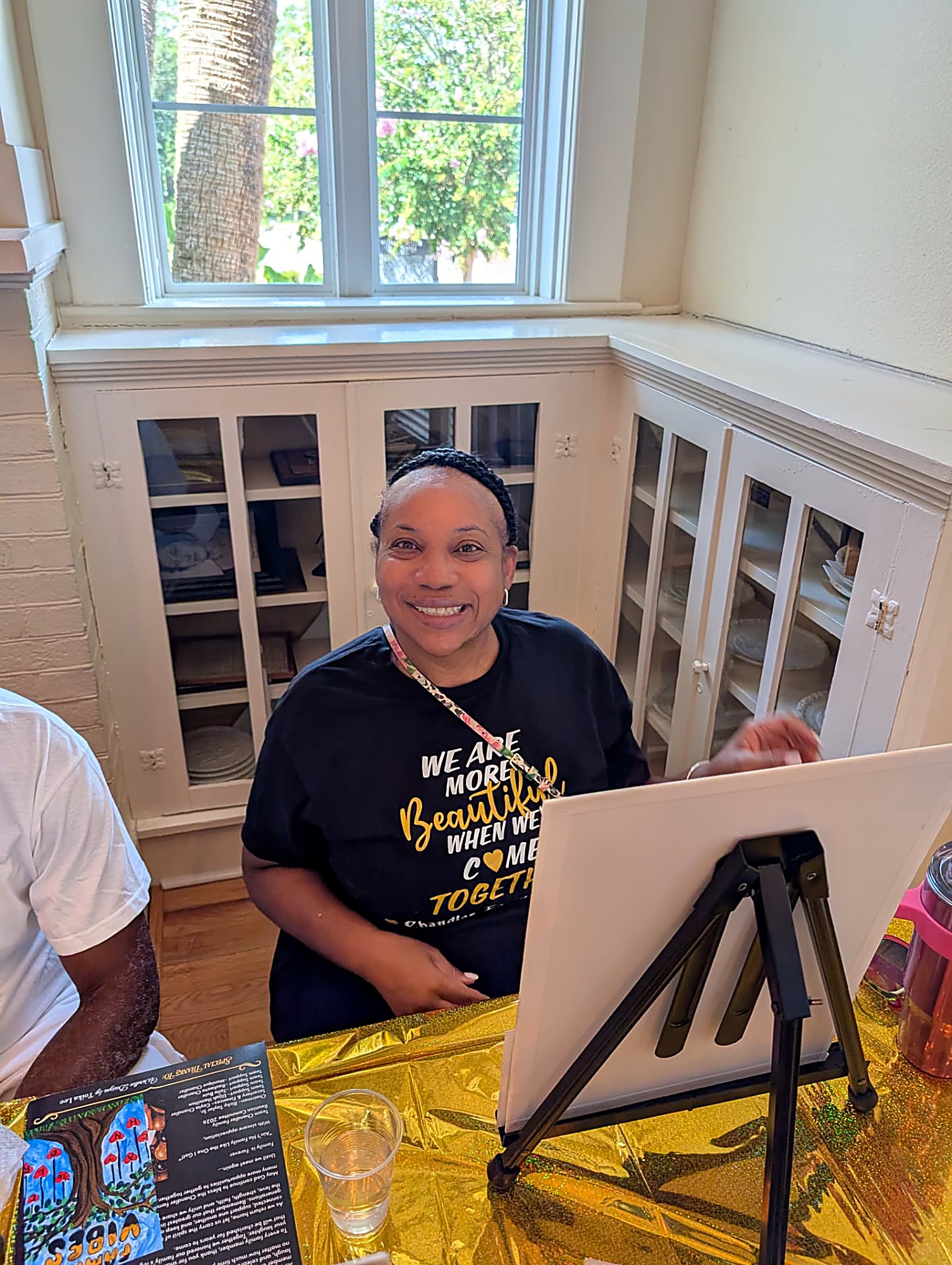 A Chandler in a 'We Are More Beautiful When We Come Together' tee at the paint party