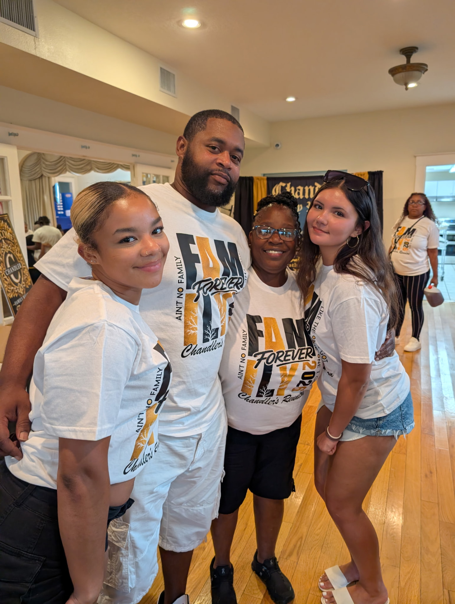 Chandler family members posing together in their Fam Forever reunion tees
