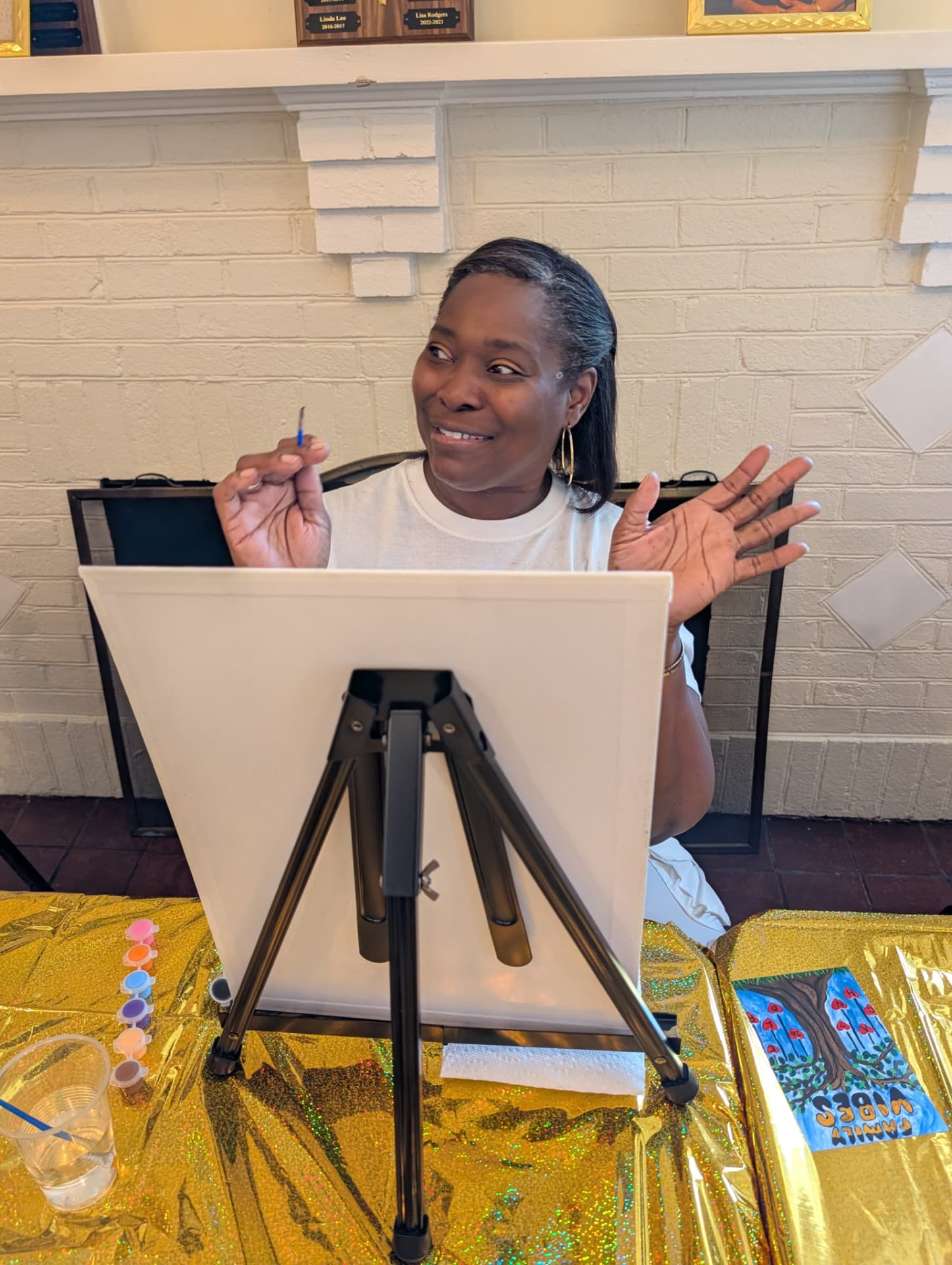 Auntie showing off her finished Family Vibes painting