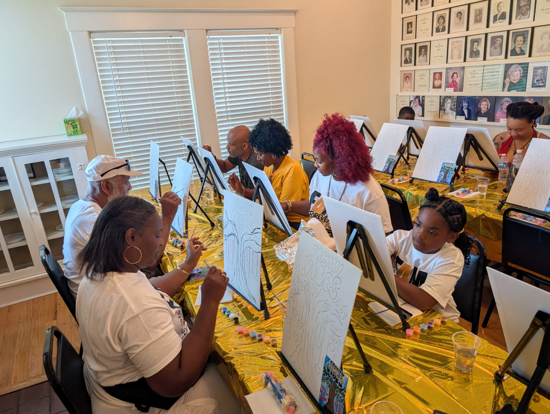 Family members painting together at the reunion paint party