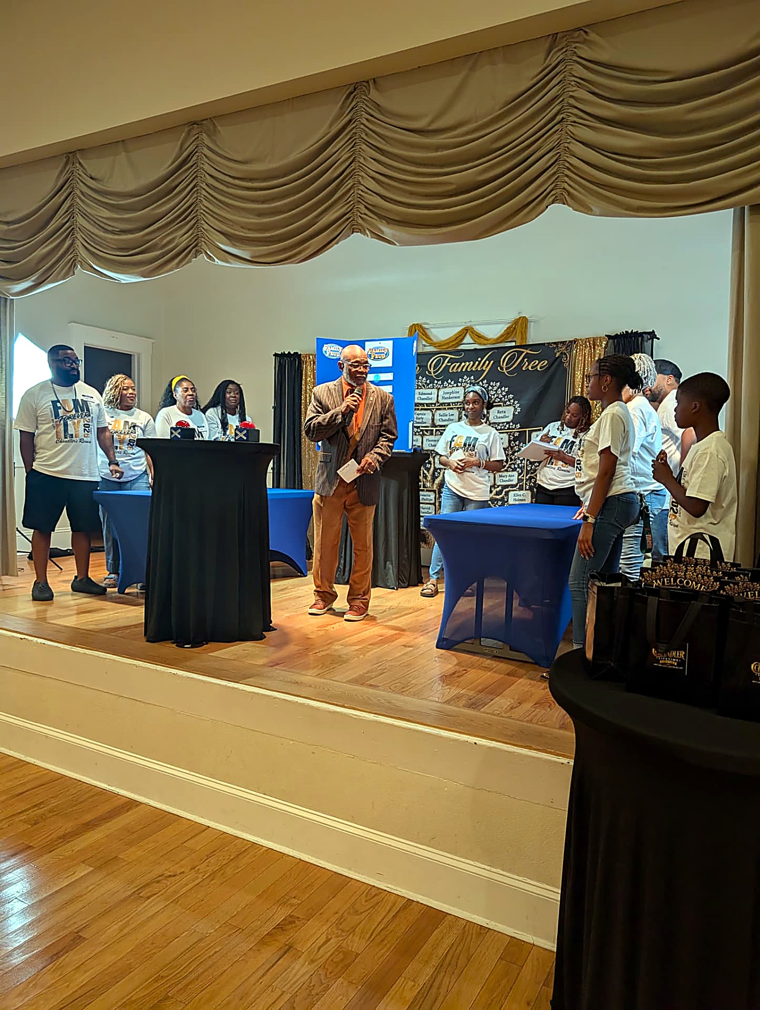 Chandler Family Feud game show on stage in front of the family tree banner