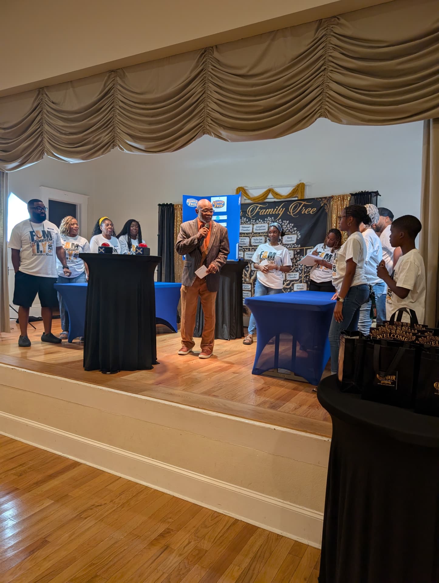 Family Feud game night on stage in front of the Chandler Family Tree banner