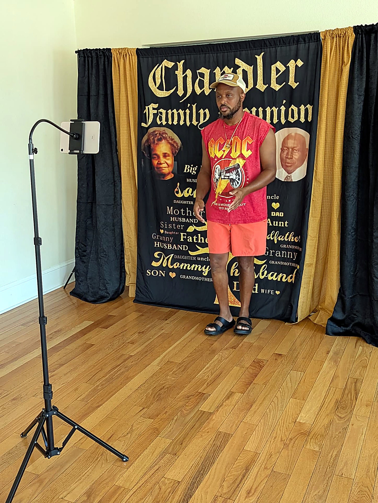 A family member speaking in front of the Chandler Family Reunion banner