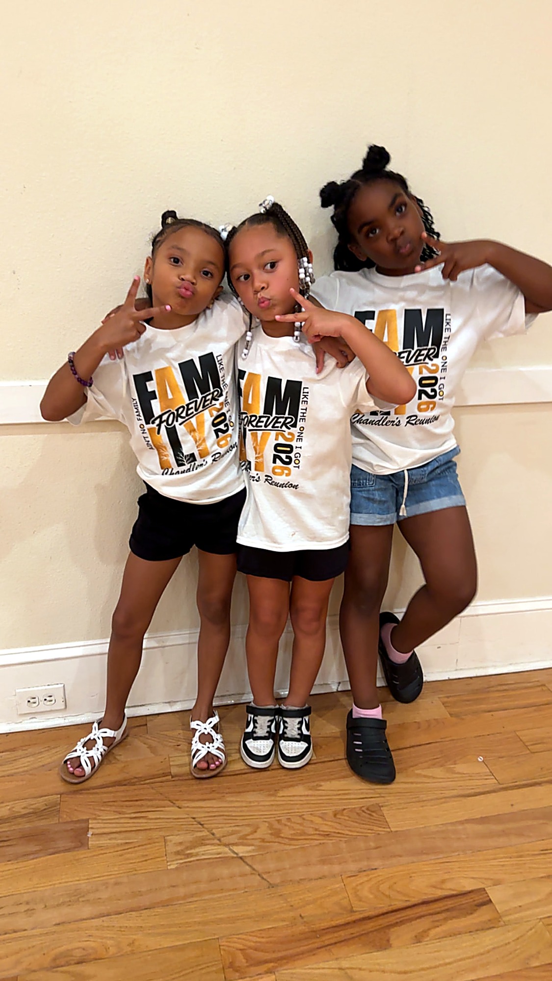 Three young cousins posing in Fam Forever 2026 reunion tees