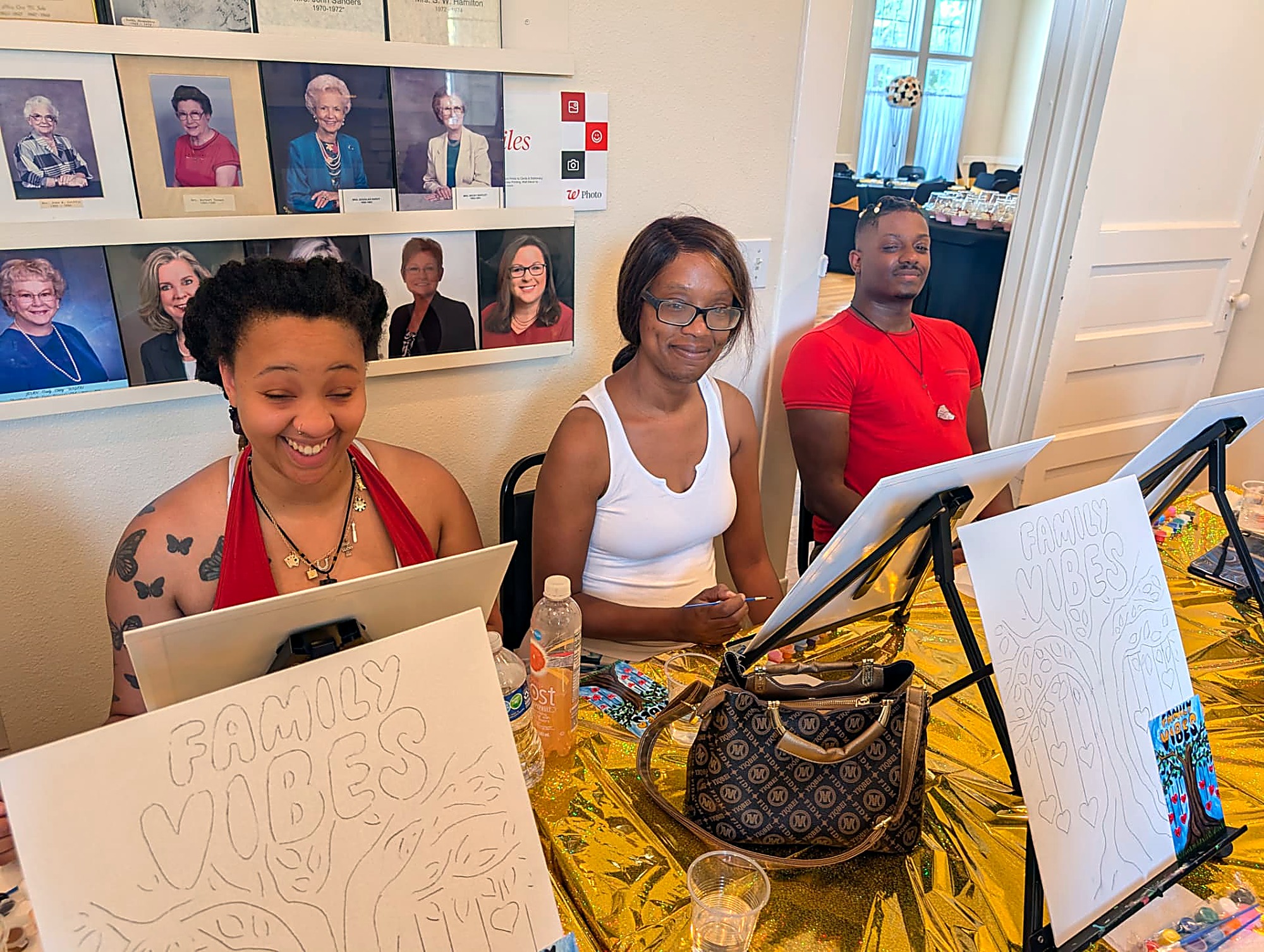 Family members sketching their Family Vibes canvases together