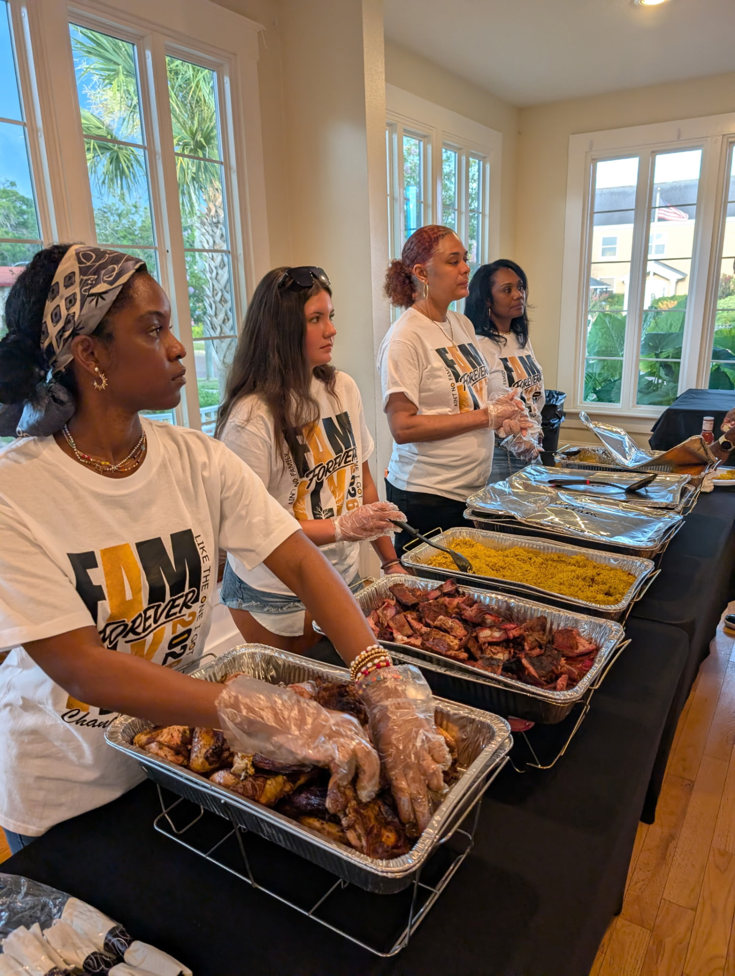 Family volunteers in Fam Forever tees serving the reunion buffet